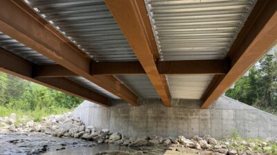 The Hendrix Road Bridge features integral abutments, channel diaphragms, an SIP form deck, and a straight (no skew) alignment.